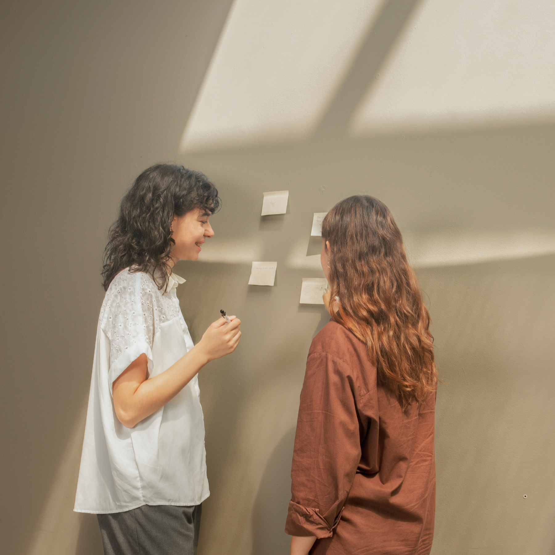 Women discussing brand and marketing strategy for their creative small business